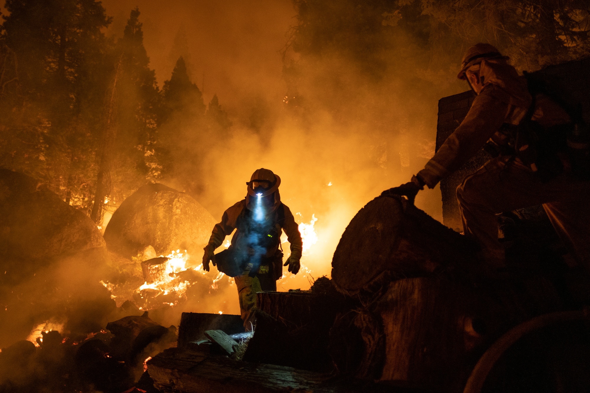 Firefighters attempt to protect a home during the Caldor Fire near Meyers, California, on Aug. 31, 2021.
