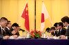 Wang Yi, China's foreign minister, second left, speaks as Taro Kono, Japan's foreign minister, second right, listens during a meeting in Tokyo.