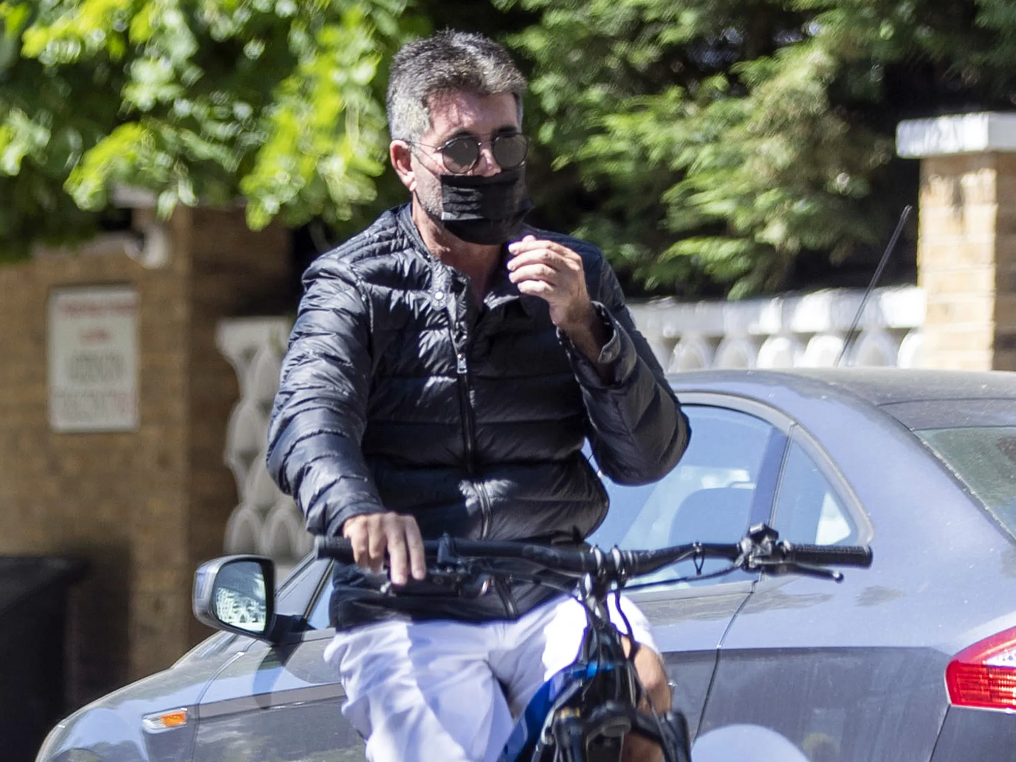 Simon Cowell riding an e-bike in London in June 2021.