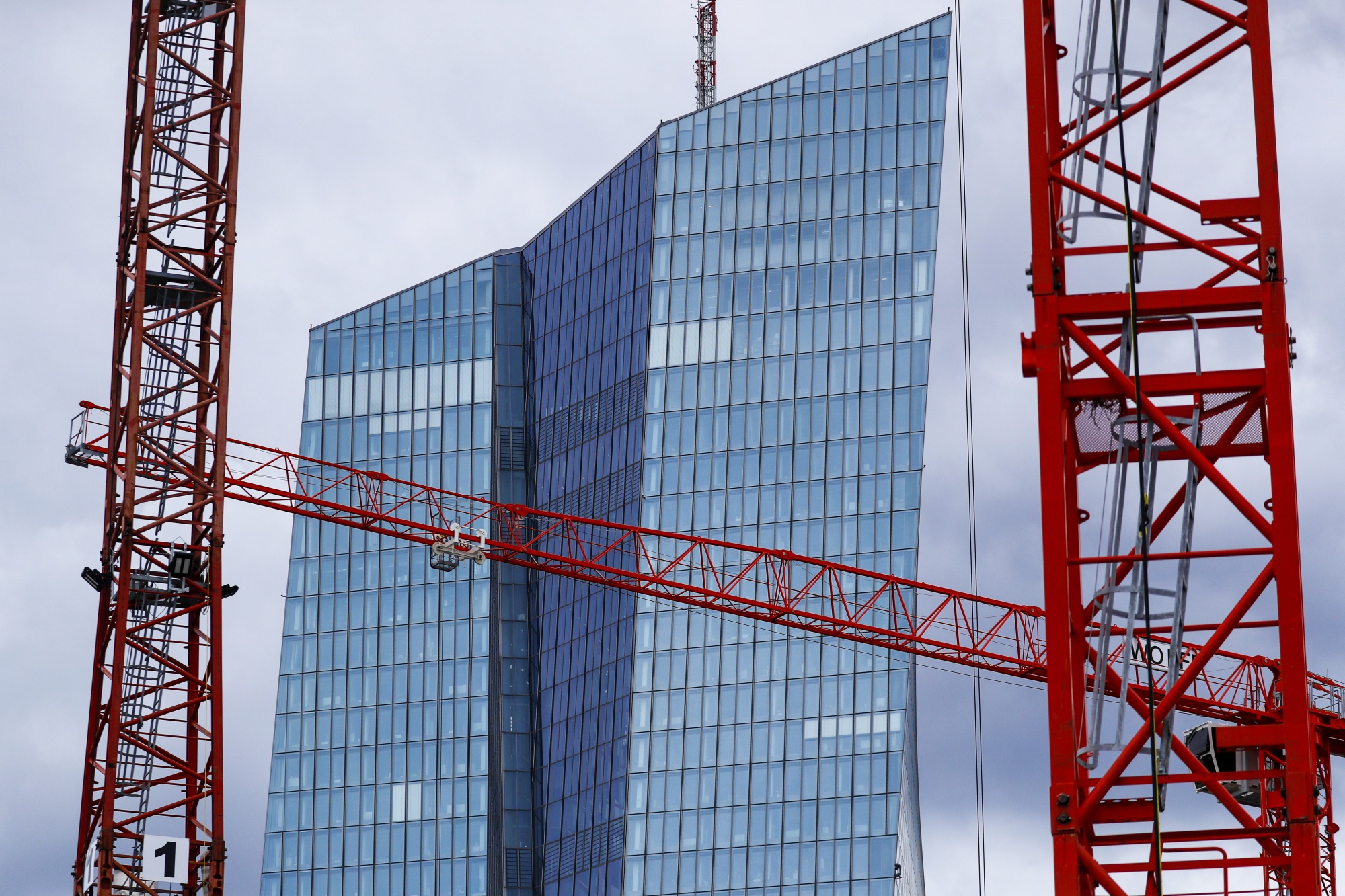 Cranes stand in front of the European Central Bank (ECB) headquarters in Frankfurt, Germany, on Wednesday, April 29, 2020. The ECB's response to the coronavirus has calmed markets while setting it on a path that could test its commitment to the mission to keep prices stable.