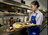 Waitress Ashley Ove picks up an order in the kitchen of an IHOP restaurant on Route 46 in Totowa, New Jersey, Monday, July 16, 2007. 
