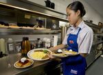 Waitress Ashley Ove picks up an order in the kitchen of an IHOP restaurant on Route 46 in Totowa, New Jersey, Monday, July 16, 2007.&nbsp;