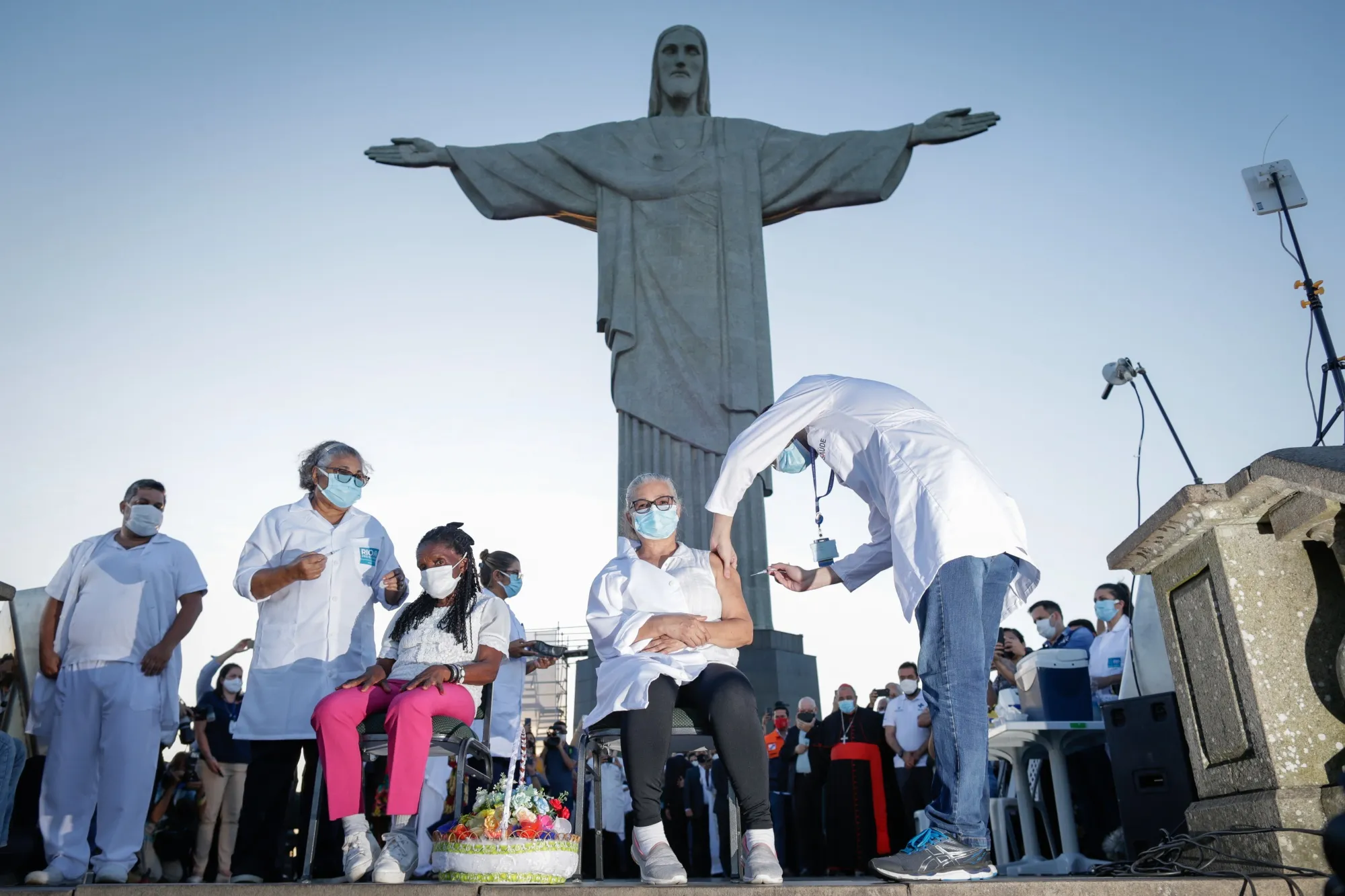A healthcare worker administers a dose of the Sinovac Biotech Ltd. coronavirus vaccine at the Christ the Redeemer statue in Rio de Janeiro, Brazil.