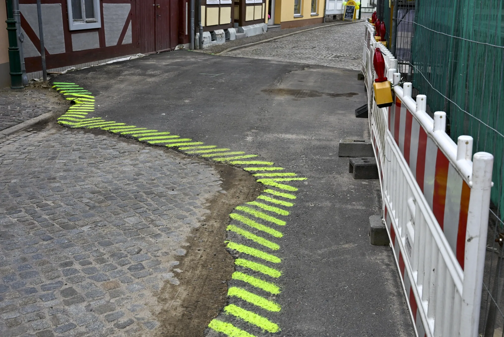 A danger spot of a road,&nbsp;marked with colored stripes, in Brandenburg, Perleberg.