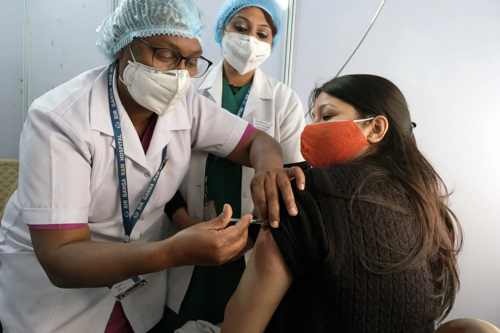 A staff member administers a Covishield vaccine at the Ganga Ram Hospital in New Delhi, on Jan. 16. 