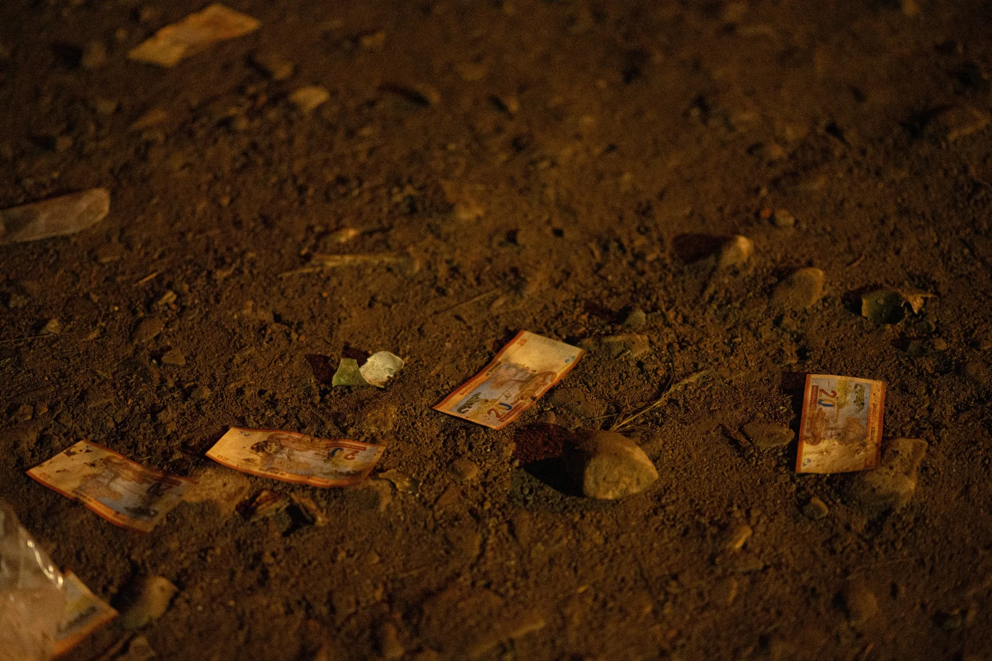Bolivianos banknotes at the scene of the crash on Feb. 27.