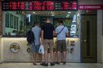 Customers exchange currencies at a foreign currency exchange bureau in Istanbul, on Aug. 11.