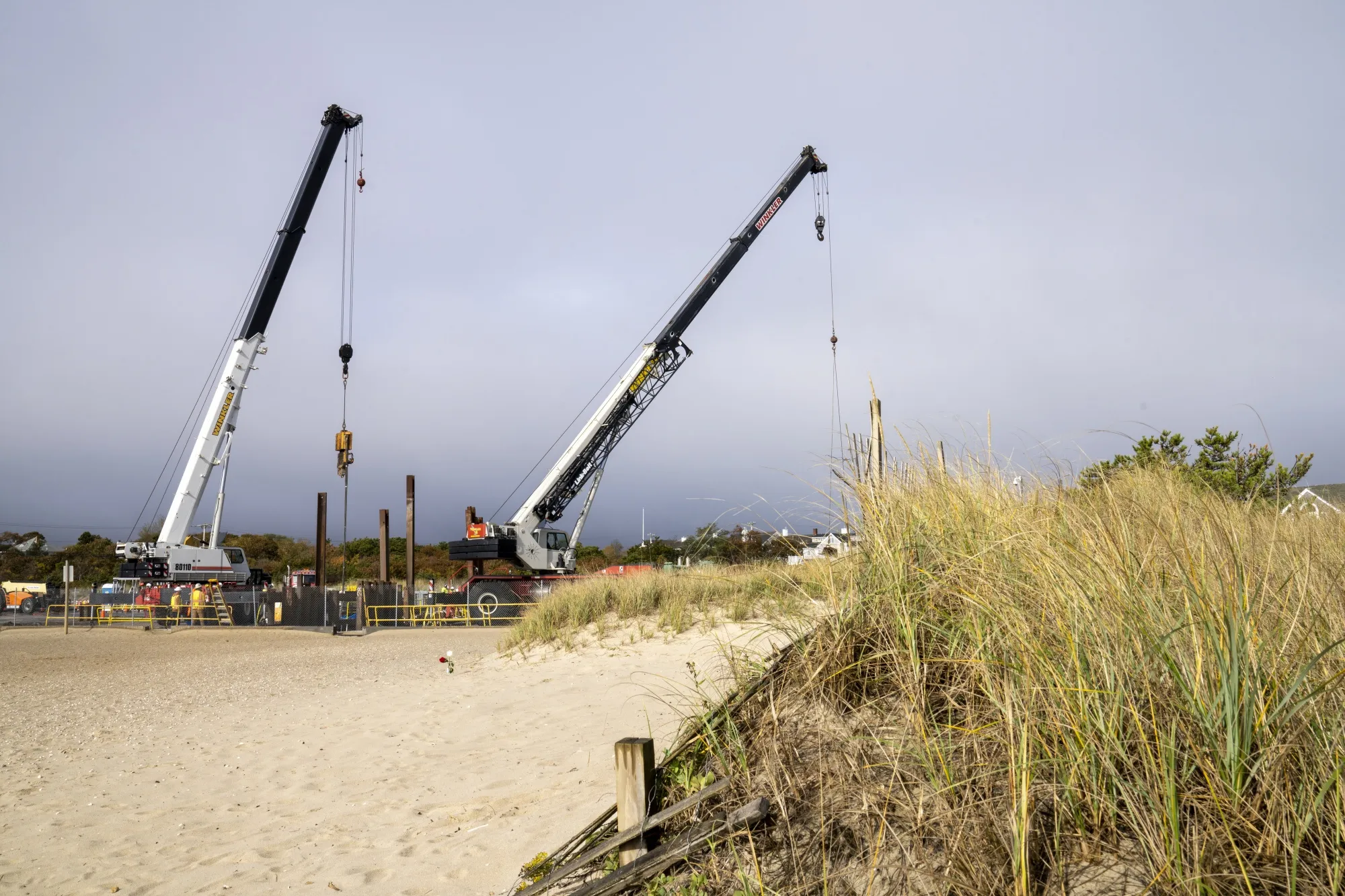 Cranes lift steel shoring, where submarine cables come onshore, at the Vineyard Wind project under construction in Barnstable, Massachusetts, US, on Tuesday, Oct. 25, 2022.