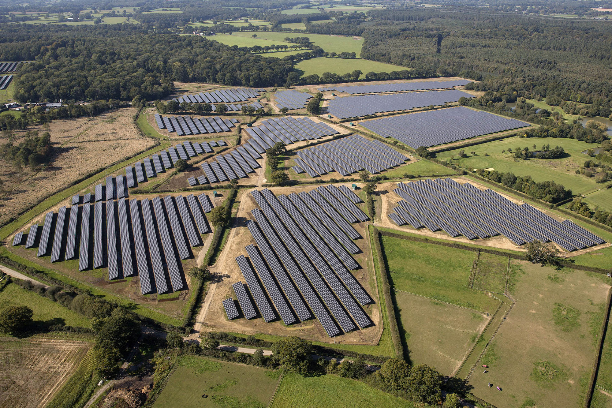 Solar panels sit in an array at the Southwick Estate Solar Farm, operated by Primrose Solar Ltd., near Fareham, U.K., on Friday, Oct. 2, 2015. The plant, situated in 200 acres (81 hectares) of farmland, consists of 175,000 monocrystalline PV modules and has a capacity of 48 megawatts.
