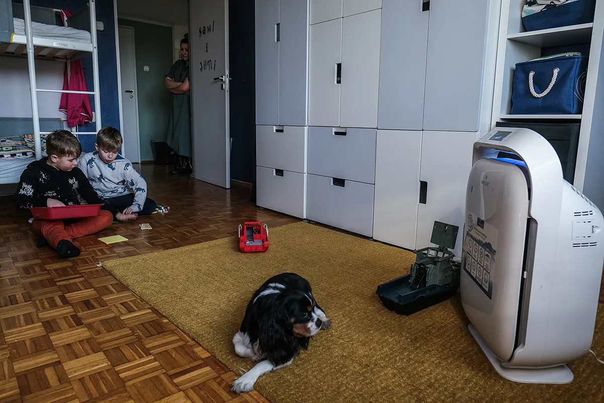 Children in Rybnik, Poland play near the air purifier in their bedroom.