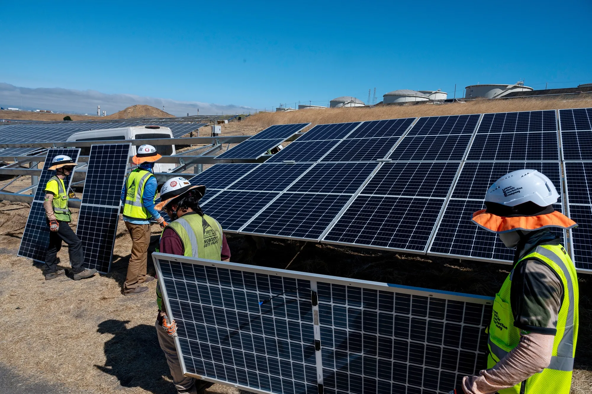 Contractors install solar panels.