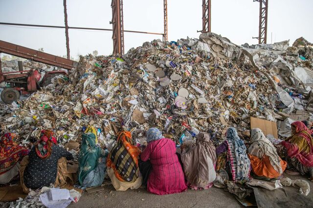Stacks of imported raw materials containing a percentage of plastic waste including bags and covers of foreign brands are sorted at a yard prior to processing them at Genus Paper & Boards Limited paper mill in Muzaffarnagar District, Uttar Pradesh, India, on Saturday, Nov. 19, 2022. Photographer: Prashanth Vishwanathan/Bloomberg