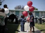 Children play at the opening of a food bank at a public housing project in Los Angeles. 
