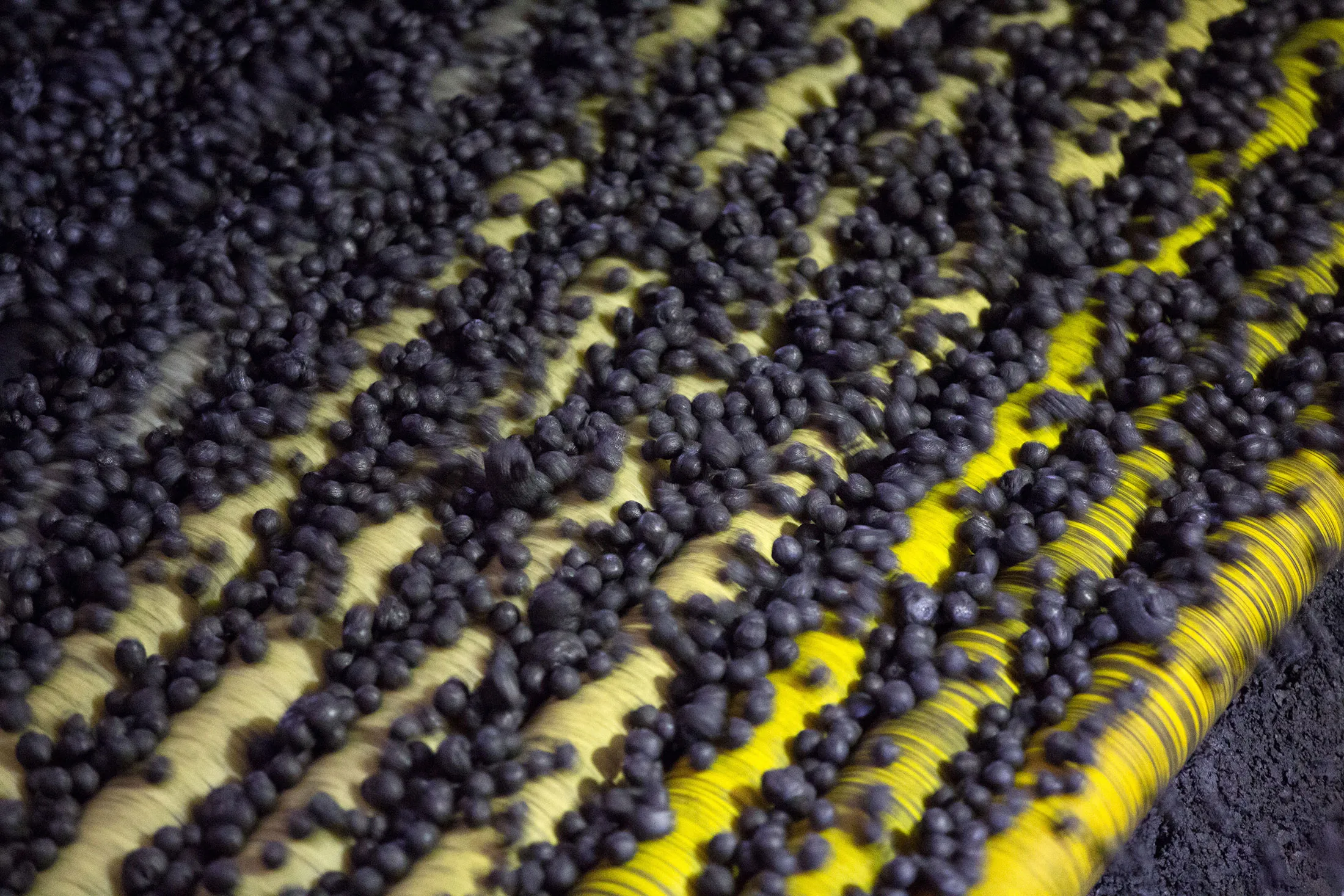 Iron ore pellets move along a conveyor belt during manufacture at the Lebedinsky GOK's (LGOK) iron ore mining and processing plant, operated by Metalloinvest Holding Co., in Gubkin, Russia, on Tuesday, May 28, 2013. Lebedinsky, Russia's third biggest iron ore mine, is owned 81 percent owned by Russian billionaire Alisher Usmanov, who also owns Mikhailovsky GOK, Russia's second-biggest iron ore mine, and Oskol Electrometallurgical Combine, a steel plant supplied by Lebedinsky.
