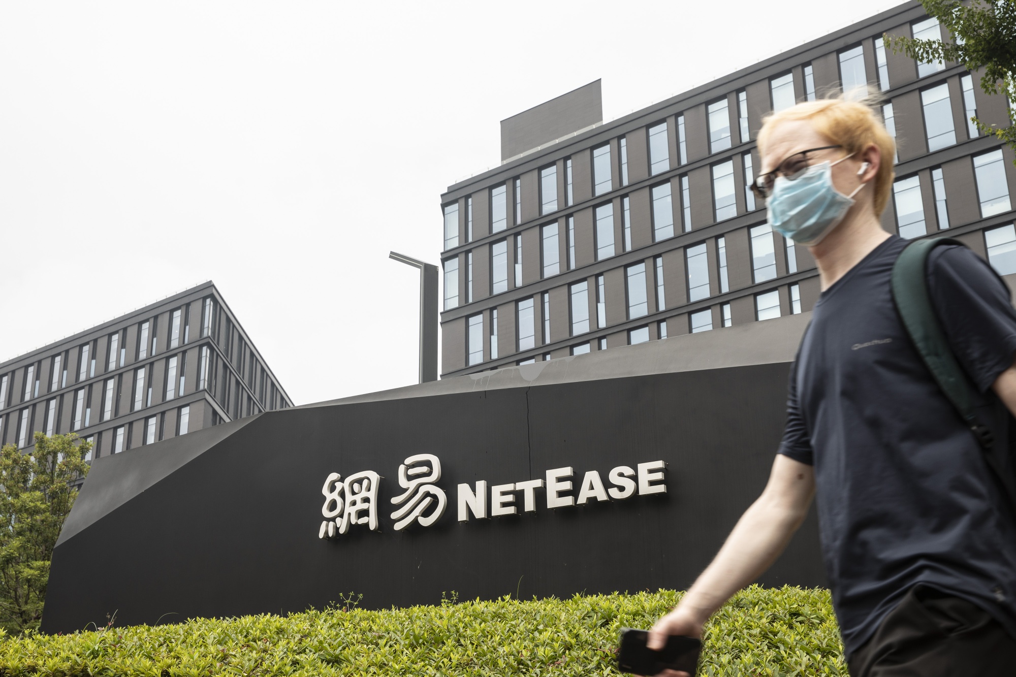 A pedestrian walks past&nbsp;the NetEase Inc. campus in Hangzhou.