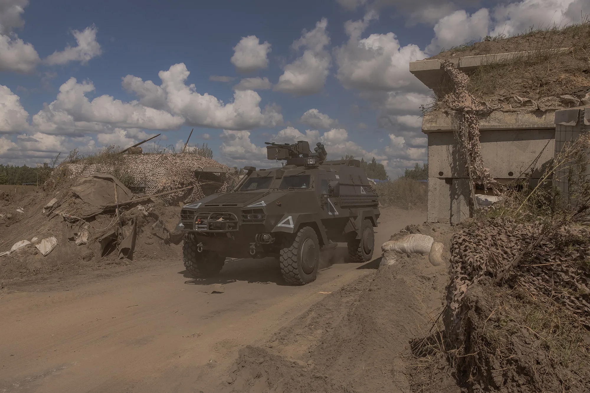 A Ukrainian military vehicle drives&nbsp;past a destroyed border crossing point with Russia, in the Sumy region, on Aug.&nbsp;14.