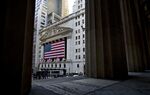 A U.S. flag hangs outside the facade of the New York Stock Exchange.
