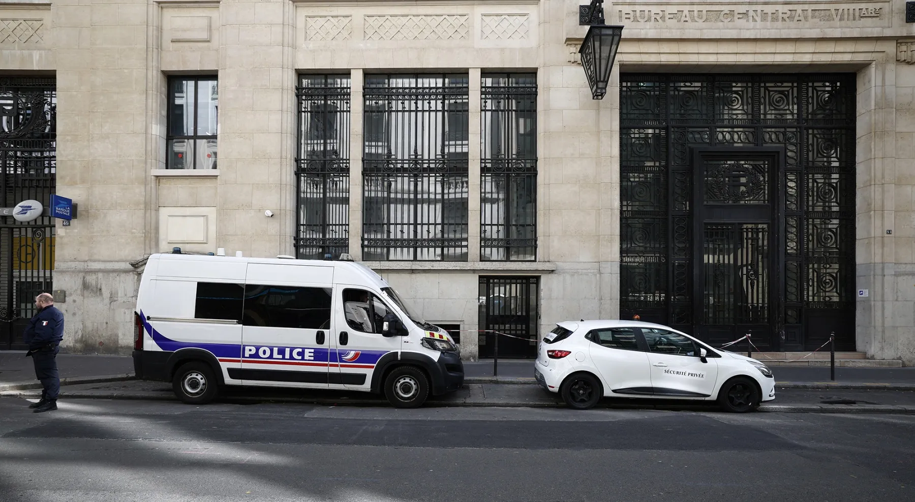 Police and private security vehicles outside The Bank of America building in Paris on March 28.