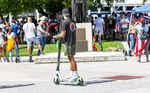 A person rides a scooter at Bayfront Park in Miami.