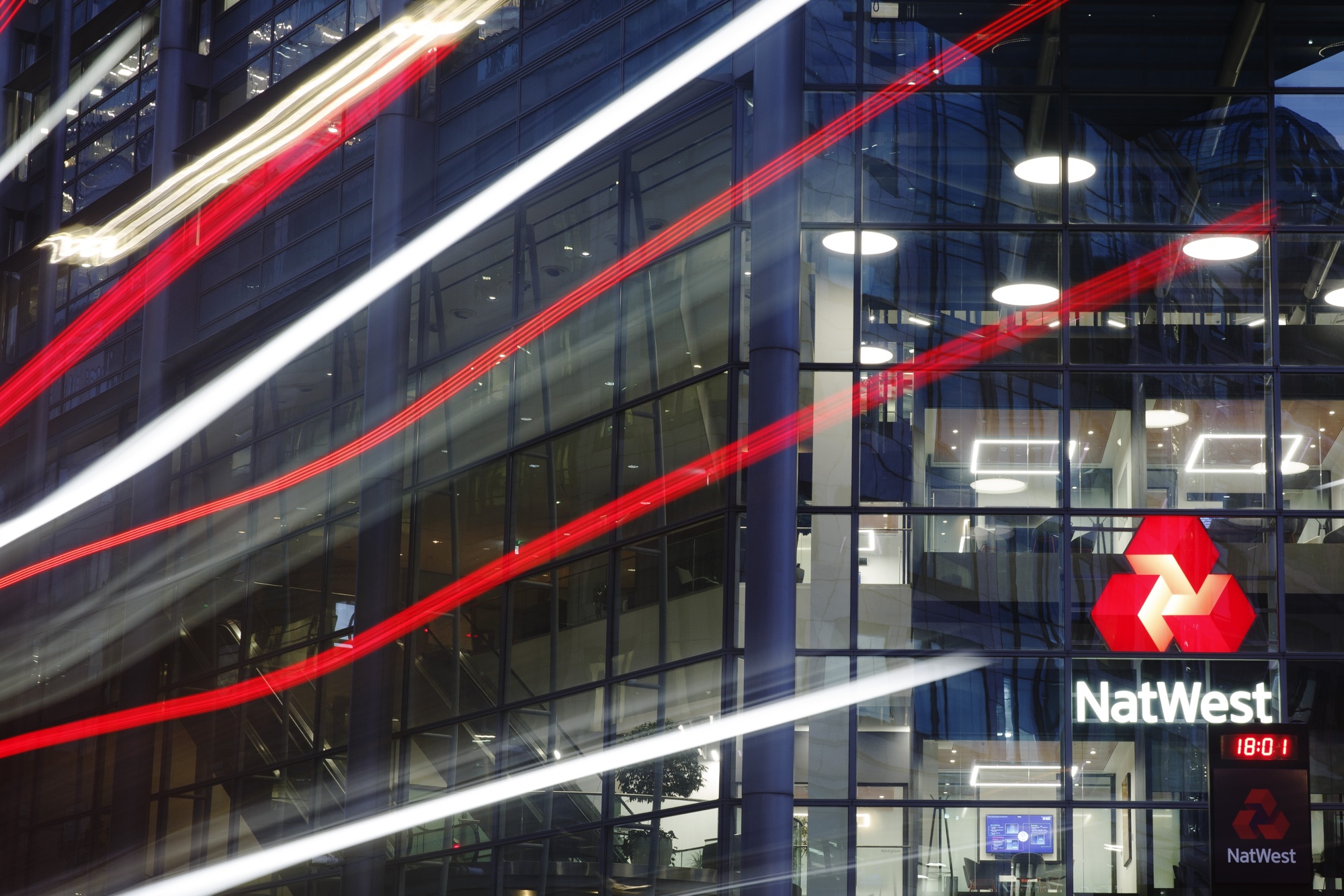 A bus passes NatWest Group Plc offices in London, UK