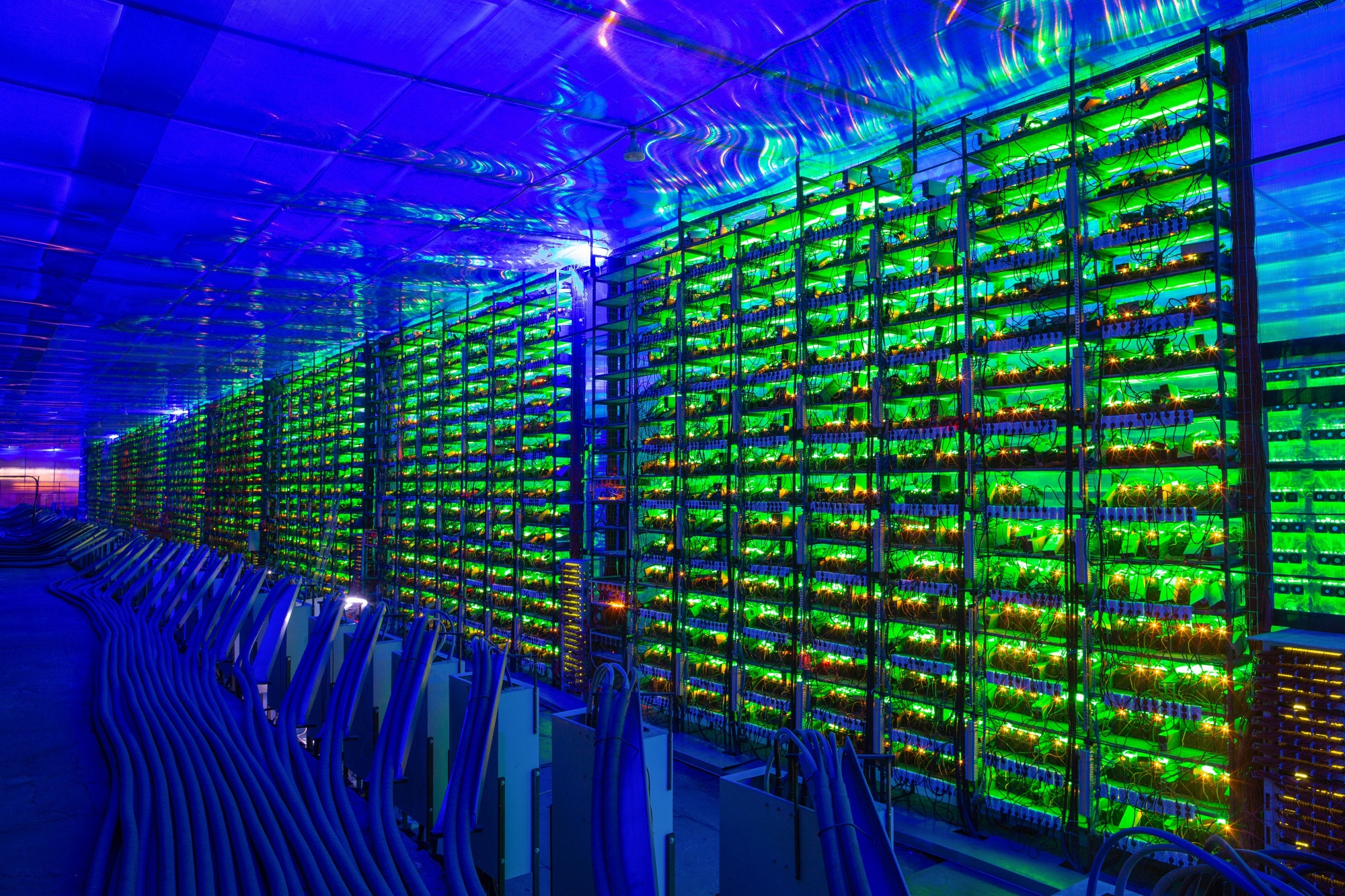 Illuminated mining rigs operate inside racks at the CryptoUniverse cryptocurrency mining farm in Nadvoitsy, Russia. The rise of Bitcoin and other cryptocurrencies has prompted the greatest push yet among central banks to develop their own digital currencies.