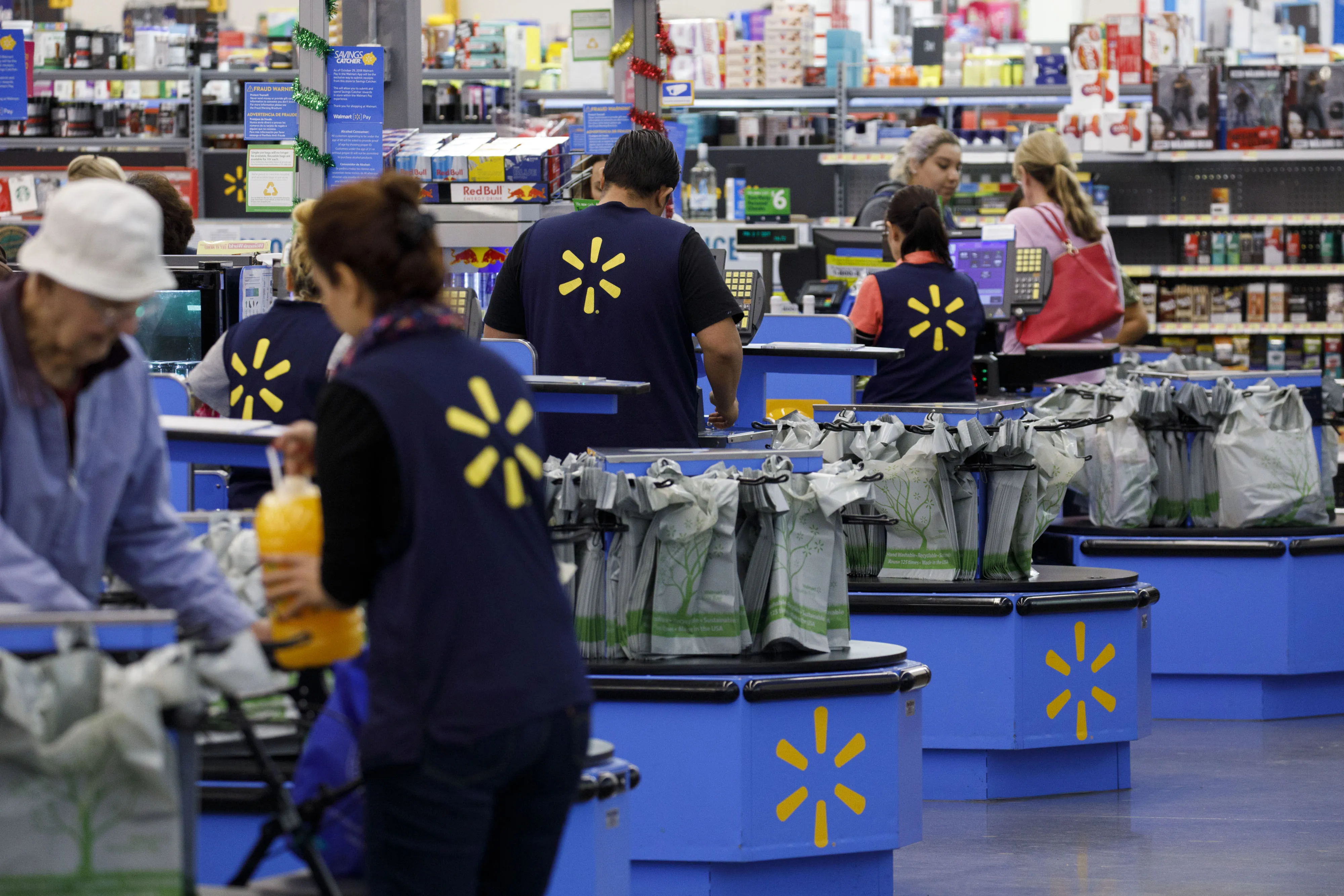 Cashiers ring up shoppers at a Walmart Inc. store in Burbank, California.