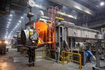 A worker pours molten aluminum from a crucible in the foundry at an aluminum smelting plant in Shelekhov, Russia.