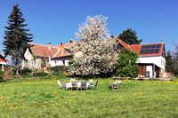 South-facing solar panels and cherry blossoms at an old farmhouse in Austria
