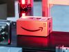 Amazon.com Inc. logo sits on a box.