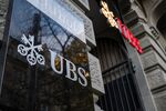 Signage outside the headquarters of UBS Group AG in Zurich, Switzerland, on Wednesday, Oct. 29, 2025. The Zurich-based bank said net income in the third quarter of the year was $2.5 billion, compared with a consensus for $1.4 billion.