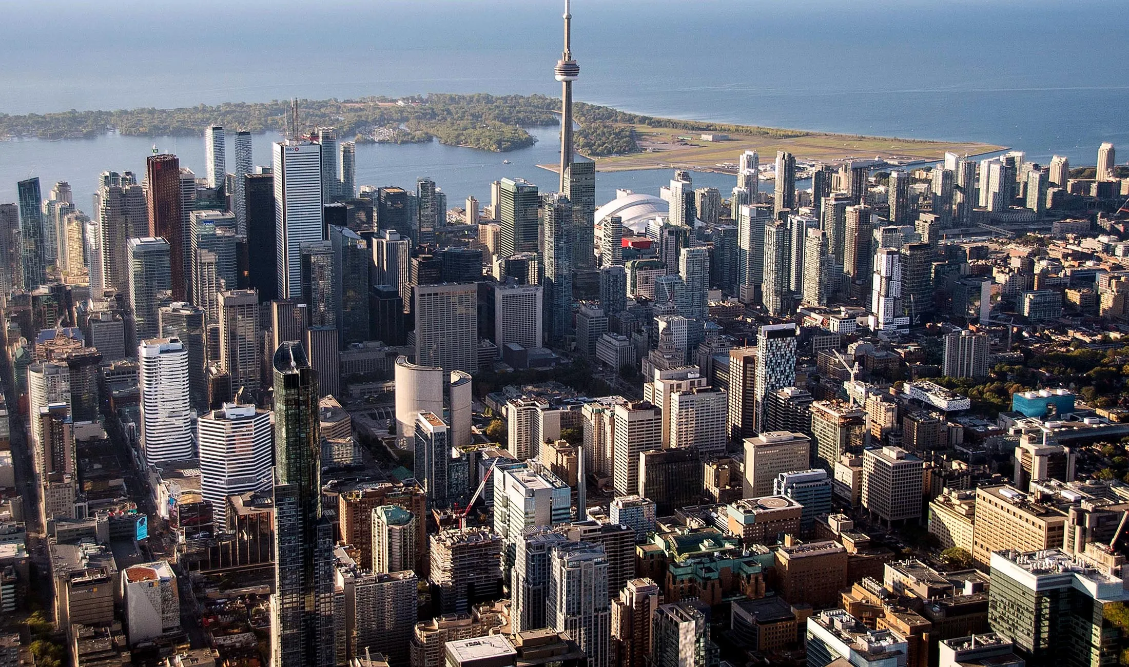 The CN Tower stands among buildings in the downtown skyline in this aerial photograph taken above Toronto.