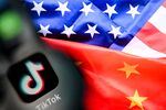 A photo taken on April 10, 2025 shows the Chinese social networking service TikTok's logo on a smartphone screen (L) and US' and China flags combo illustration on a laptop screen in Frankfurt am Main, western Germany. US President Donald Trump said on April 6, 2025 that China would have agreed to a deal on the sale of TikTok if it were not for the tariffs imposed by Washington on Beijing last week. (Photo by Kirill KUDRYAVTSEV / AFP) (Photo by KIRILL KUDRYAVTSEV/AFP via Getty Images)
