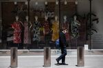 A pedestrian wearing a protective mask passes in front of an H&M store temporarily closed in the Times Square area of New York on May 12.