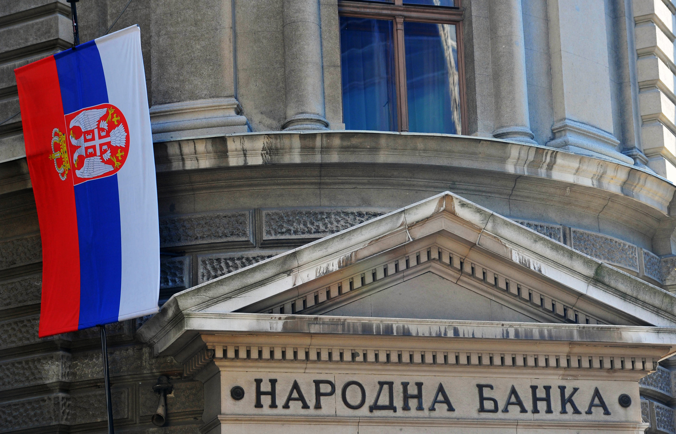 The Serbian national flag flies outside Serbia's central bank, in Belgrade, Serbia, on Sunday, Oct. 20, 2013.