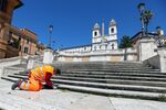 A municipal worker clears weeds from the Spanish Steps in Rome. To help defray maintenance costs, the city is asking private companies to sponsor historic sites. 