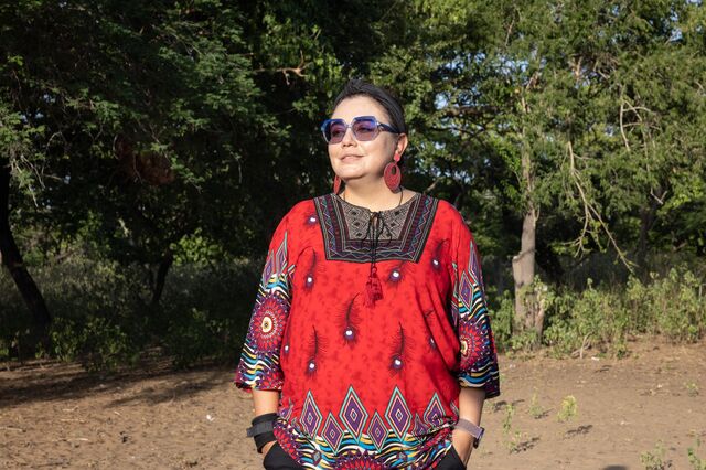 A portrait of Carol Varela outside.