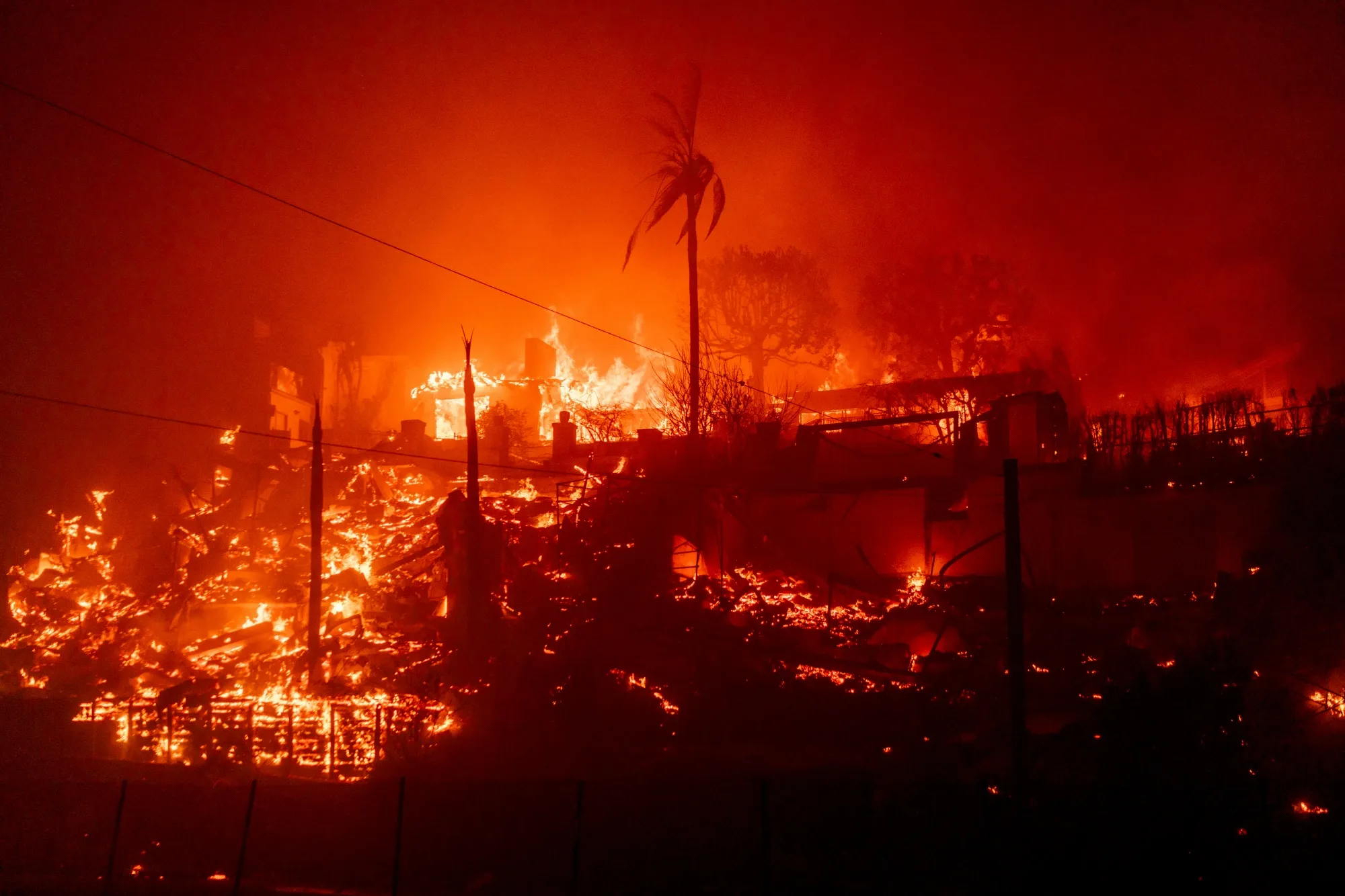 Houses burn during the Palisades Fire in the Pacific Palisades neighborhood of Los Angeles on Jan. 7.