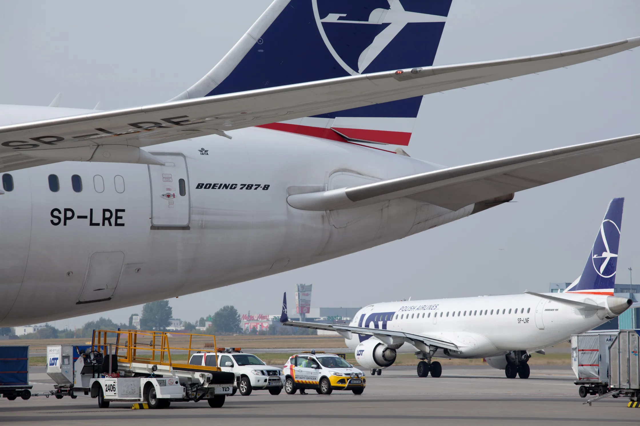 A logo for LOT Polish Airlines SA sits on the vertical stabilizer of a Boeing 787-8 Dreamliner aircraft on the tarmac at Warsaw Chopin airport in Warsaw, Poland, on Saturday, Aug. 29, 2015. Polish national airline LOT has lost its chief executive officer as the government debates whether to sell part of the company to an outside investor.
