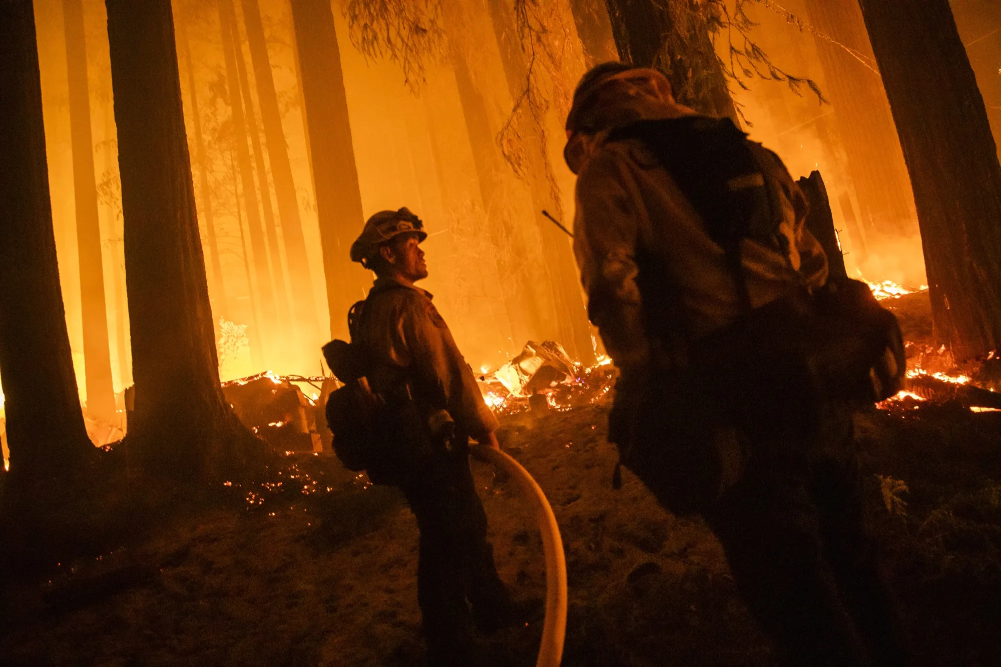 Firefighters battle the CZU Lightning Complex fire in Santa Cruz County, California in 2020.&nbsp;