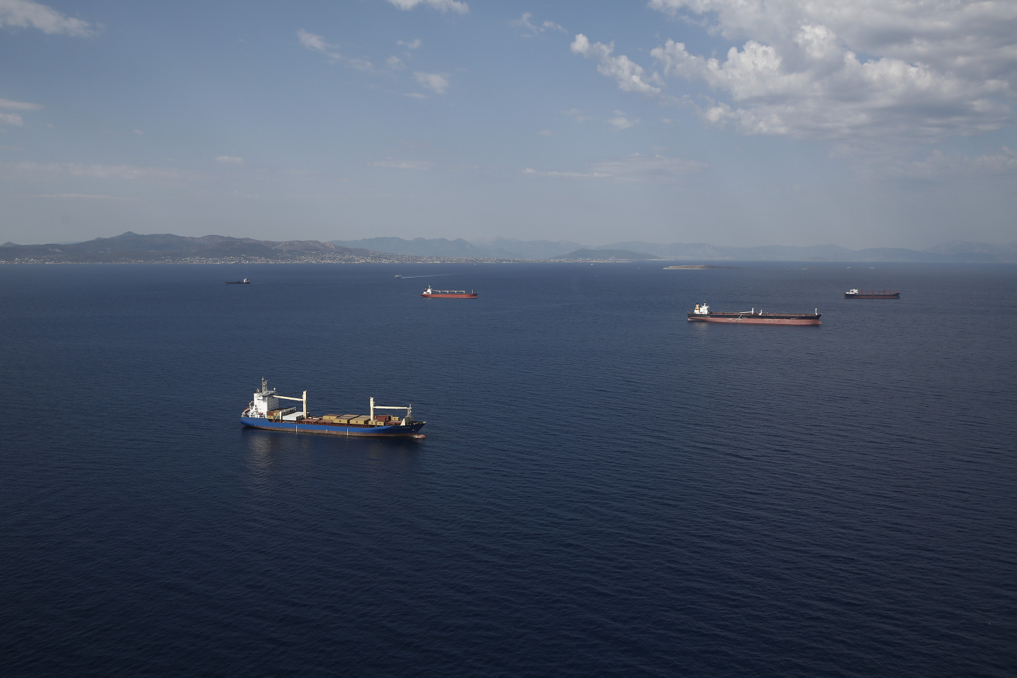 Oil tankers and container ships off the coast of Athens. Photographer: Simon Dawson
