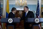 At the U.S. Department of State in Washington, D.C., Secretary of State Mike Pompeo shakes hands with Colombian Foreign Minister Carlos Holmes Trujillo on October 9, 2019.