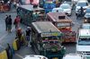 Commuters wait to board Jeepneys stuck in traffic on a road in Manila, the Philippines, on Saturday, April 8, 2017. Smoke-belching jeepneys are as iconic to Manila as the cable cars of San Francisco, the gondolas on Venice's canals and the black cabs in London. The most popular public transport in the Philippines is now being targeted for the scrap heap as President Rodrigo Duterte tries to modernize the nation and clean up its air.
