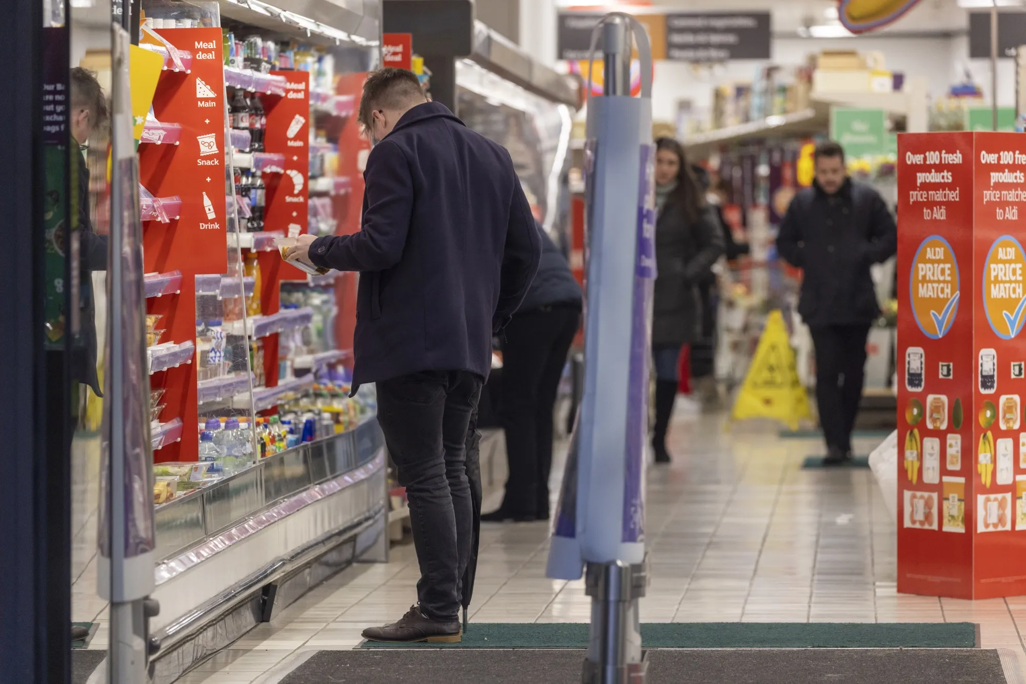 A shopper browses goods inside a Sainsbury supermarket in the UK.&nbsp;