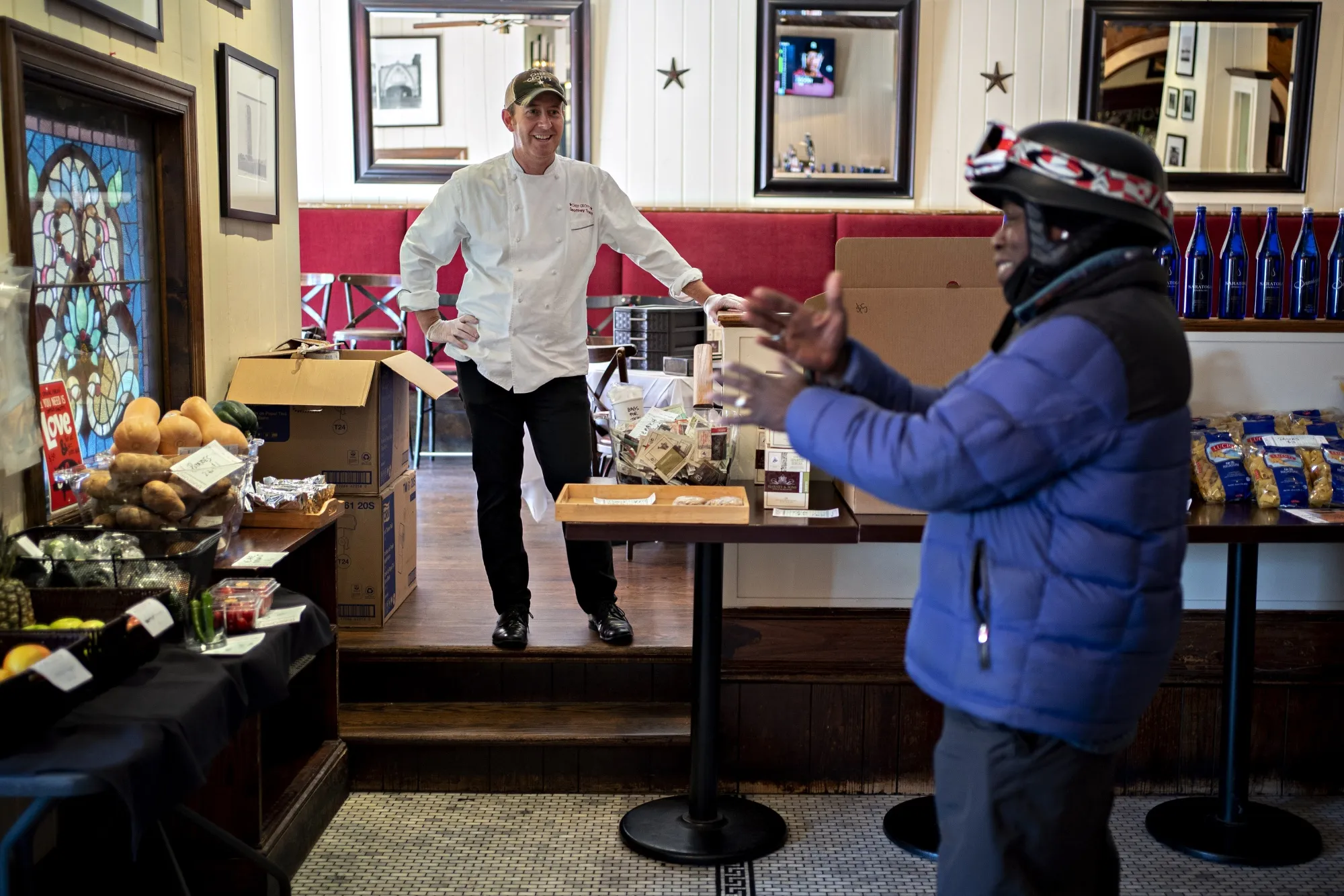A delivery worker waits for an order at Chef Geoff's restaurant in Washington, DC, in March&nbsp;2020. Food delivery services provided a lifeline for many restaurants during the pandemic.&nbsp;