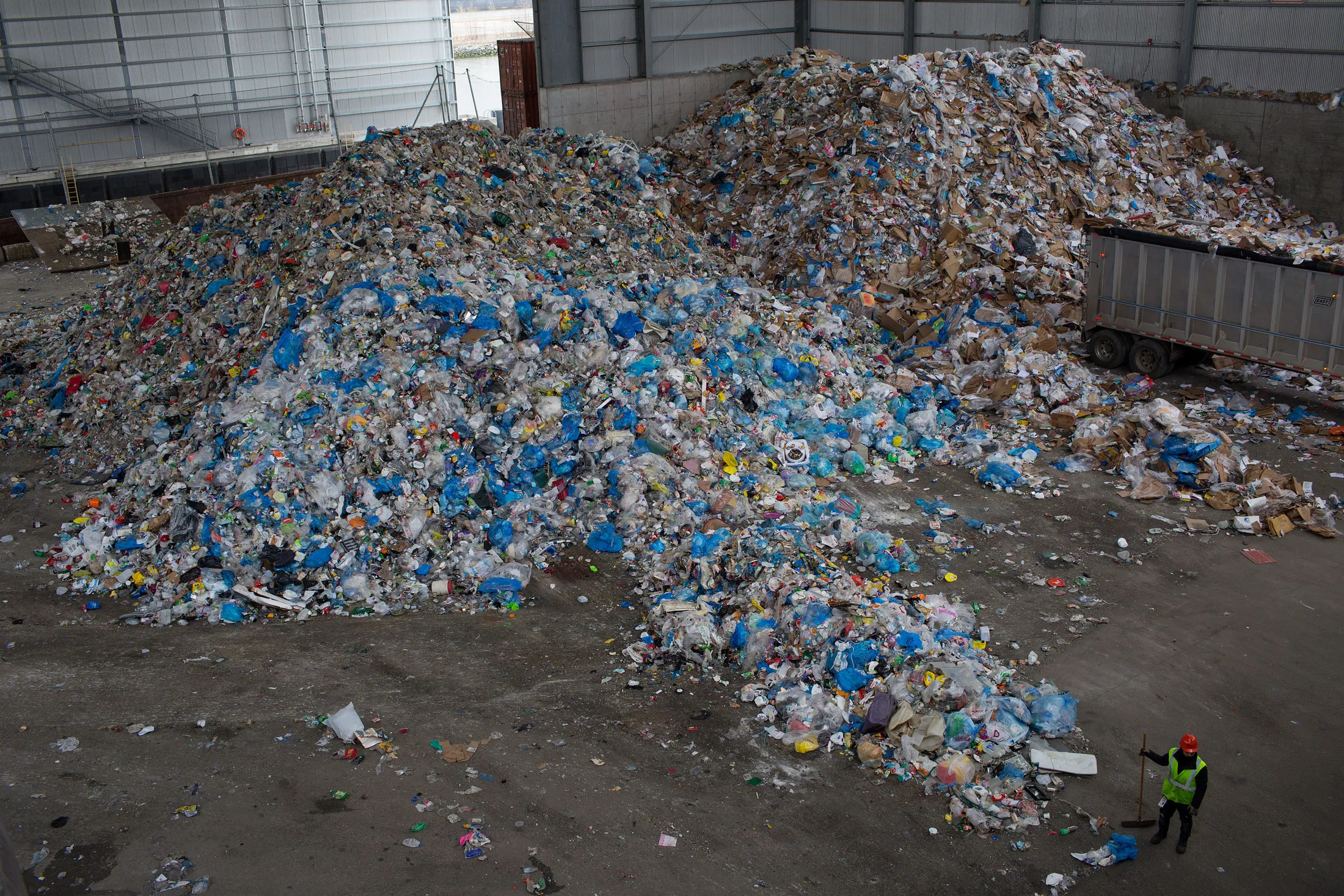 Workers collect recycled trash in Brooklyn, New York
