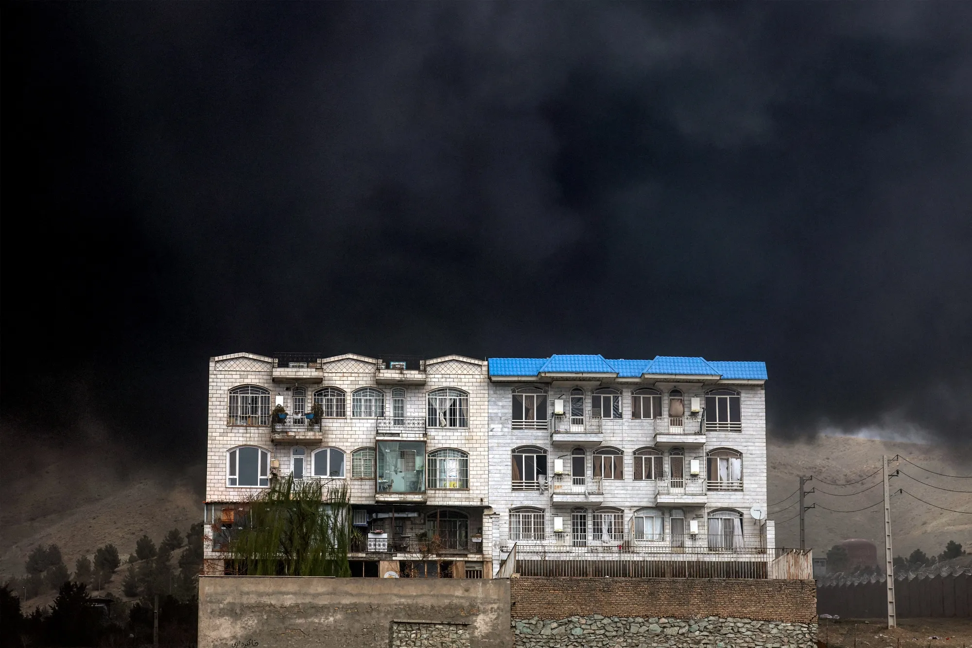 &nbsp;A dark smoke cloud engulfs a residential building&nbsp;in northwestern Tehran on March 8, 2026.&nbsp;