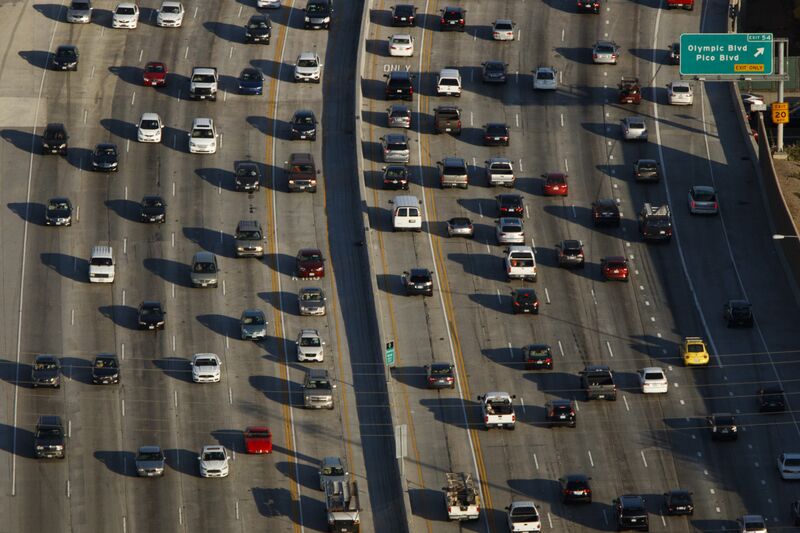 Cars sit in rush hour traffic on the 405 Freeway at Olympic Blvd in this aerial photograph taken over Los Angeles, California, U.S.