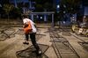 A pedestrian walks through a barricade during a protest near the student residence of the City University of Hong Kong in November 2019.