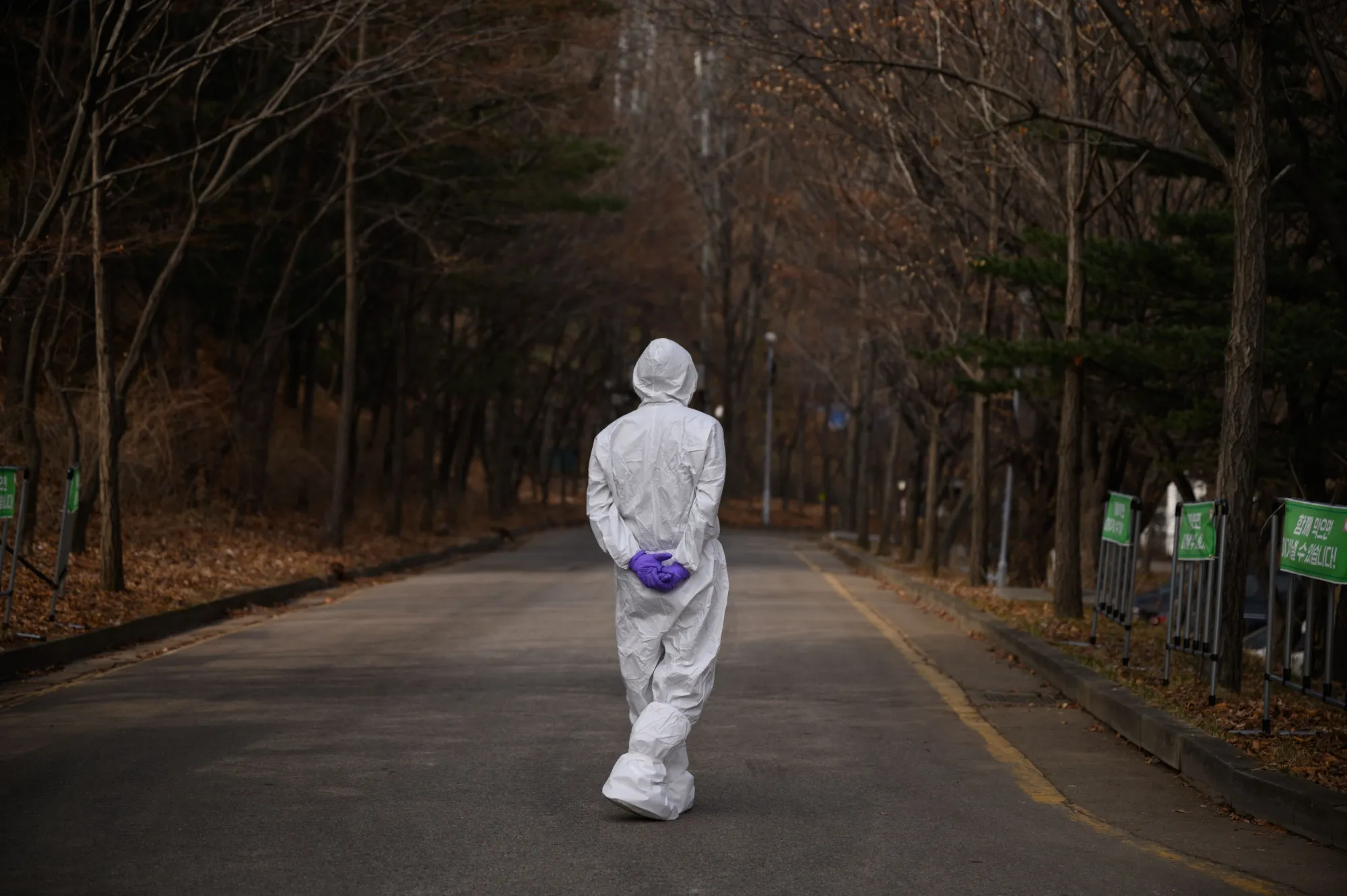 A health worker waits at a drive-through testing centre in Seoul on March 7.