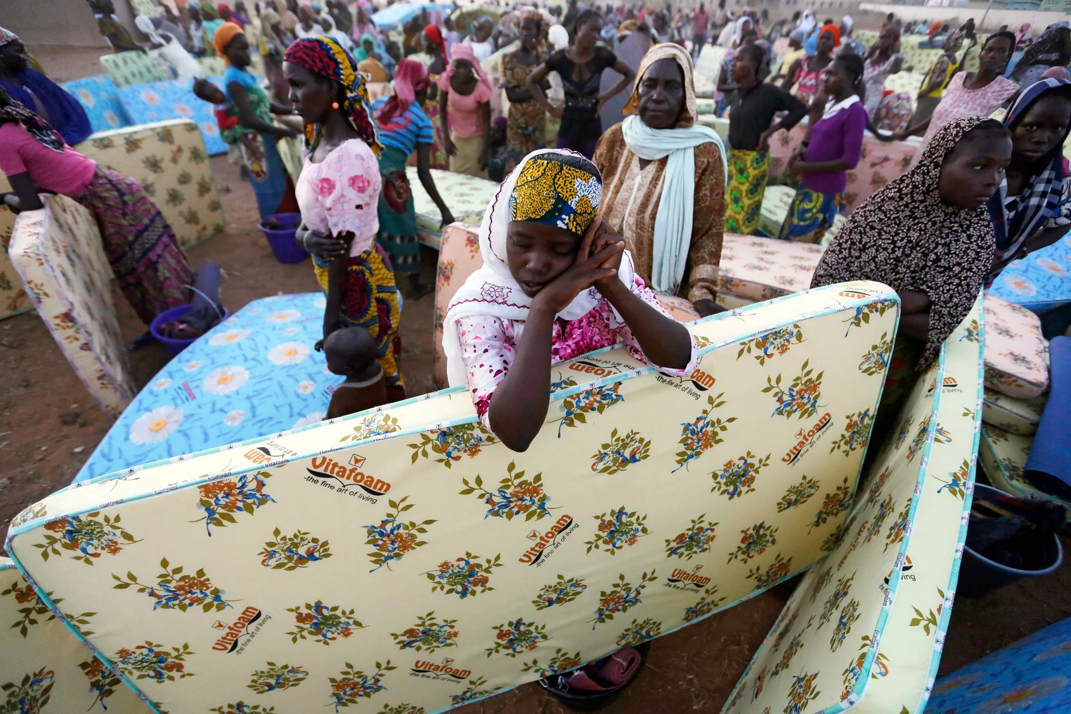 Civilians fleeing attacks by Islamist militants receive government aid at a camp for internally displaced people in Yola, Nigeria in November 2014.
